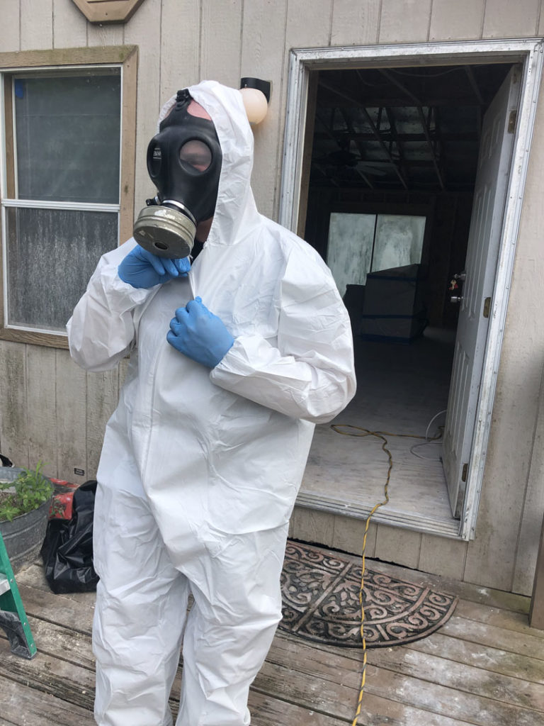 Sapphire Restoration technician in a respirator and protective suit on a mold job