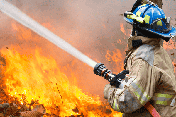 san antonio fire fighter with hose for fires in bexar county